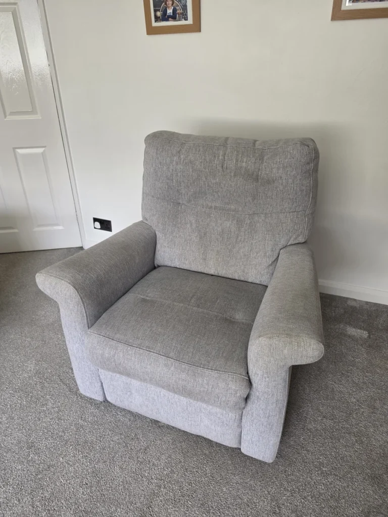 Grey fabric armchair before cleaning by New Life Carpet