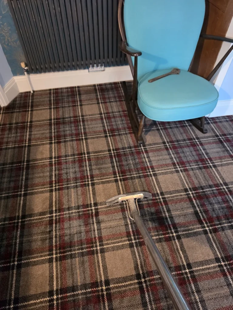 Tartan patterned carpet beside a blue chair