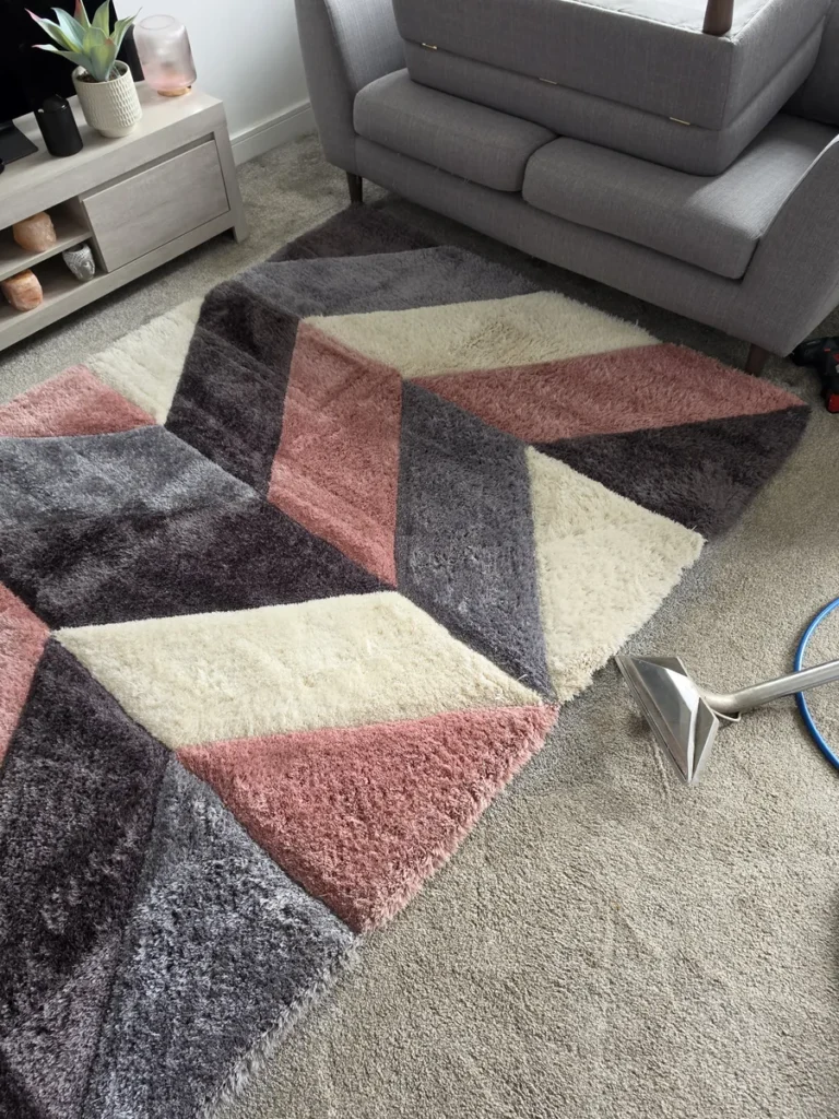 Colourful geometric rug with a carpet extraction wand in a living room