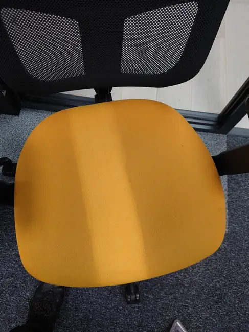 Yellow fabric office chair seat from New Life Carpet’s commercial work photographs