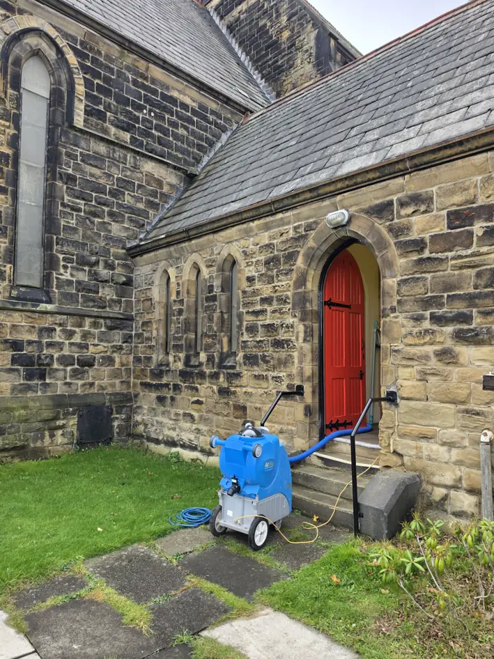 Carpet Cleaning at St Thomas Church of England 1 Carpet extraction machine outside the red church doorway at St Thomas Church of England